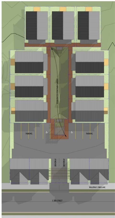 Site plan: four live/work units on the street, parking behind them, and nine cottages flanking a central green.